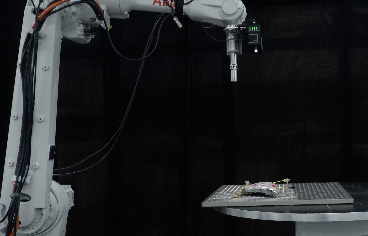A structured light scanner attached to a robotic arm, used to capture 3D geometry for robotic automation processes
